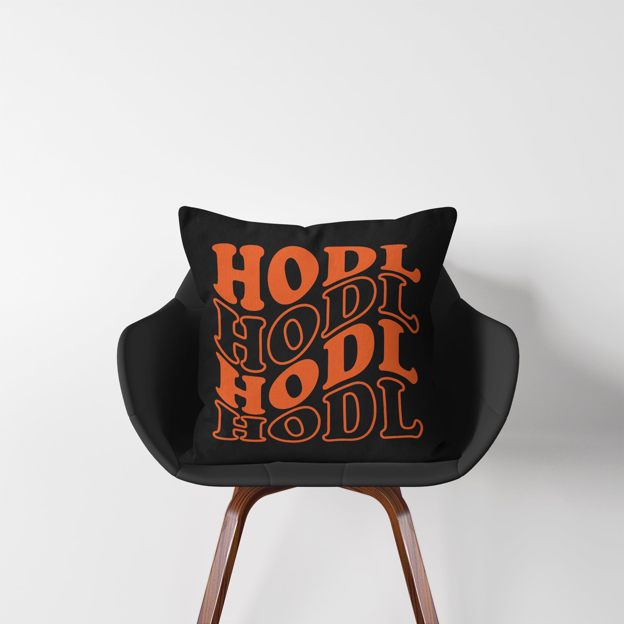 Crypto Merch - HODL Pillow displayed on a chair. 