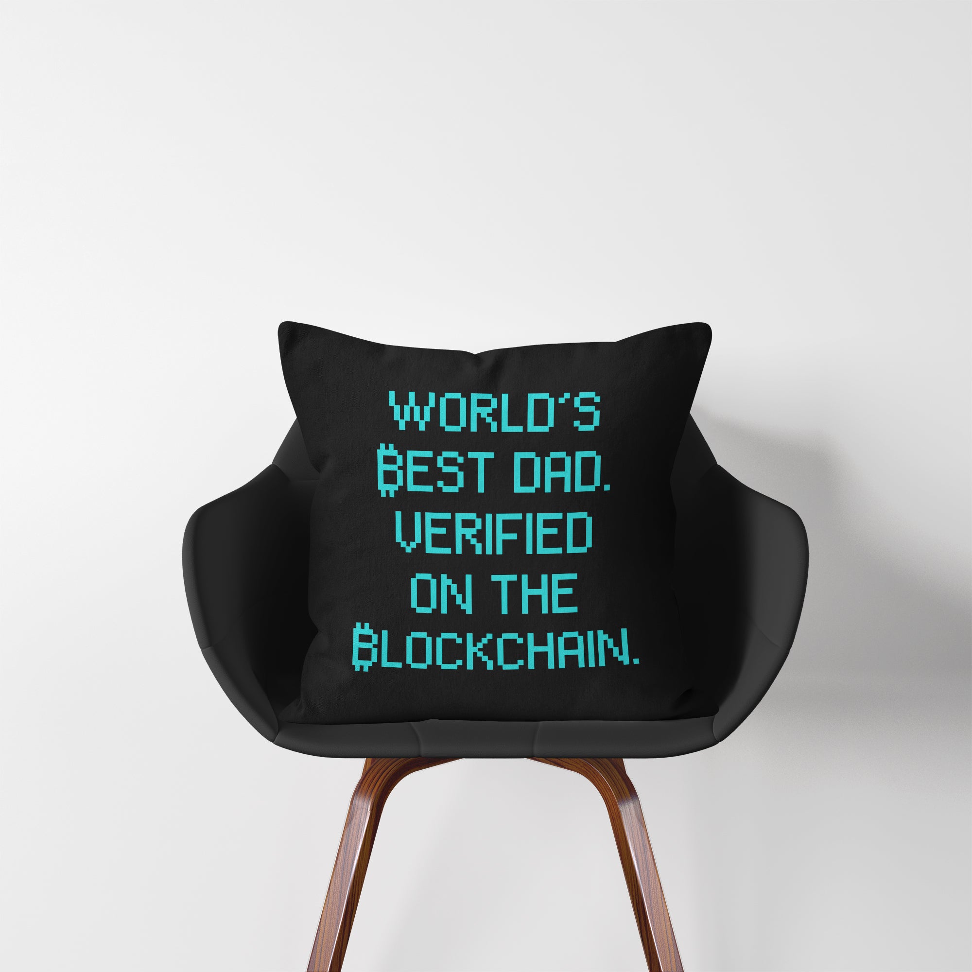 Bitcoin Decor - World's Best Dad - Verified on the Blockchain Throw Pillow displayed on a chair. Available at NEONCRYPTO STORE.