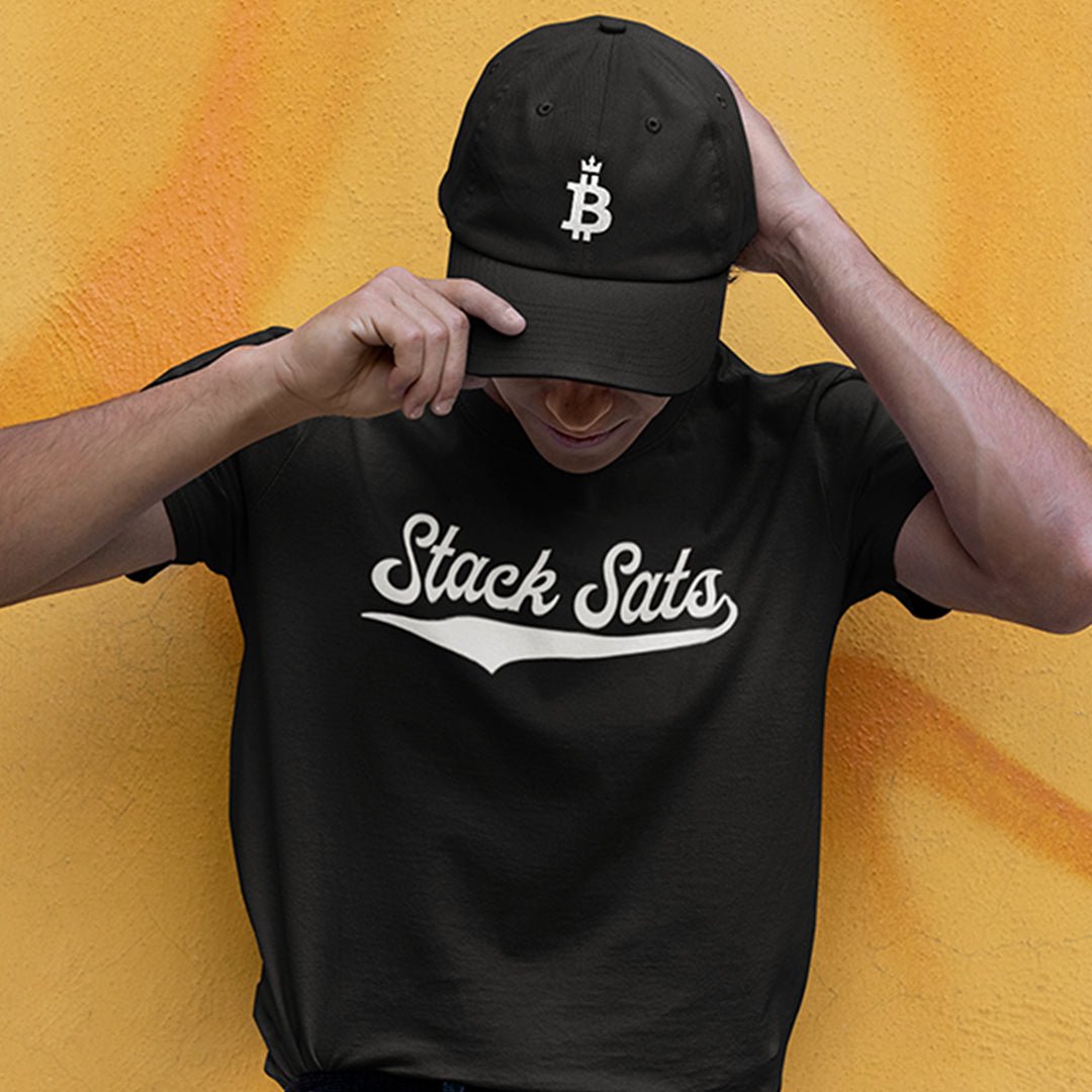 Bitcoin Dominance Hat (white logo on black cap) worn by male model. Front view.
